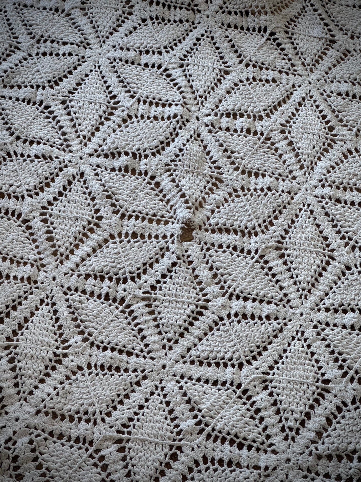 Close up of a small worn spot in the center of a floral geometric pattern