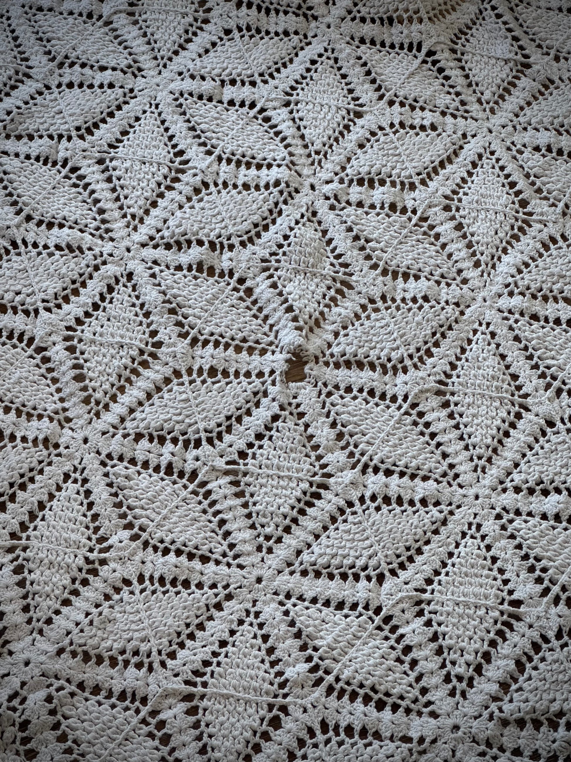 Close up of a small worn spot in the center of a floral geometric pattern
