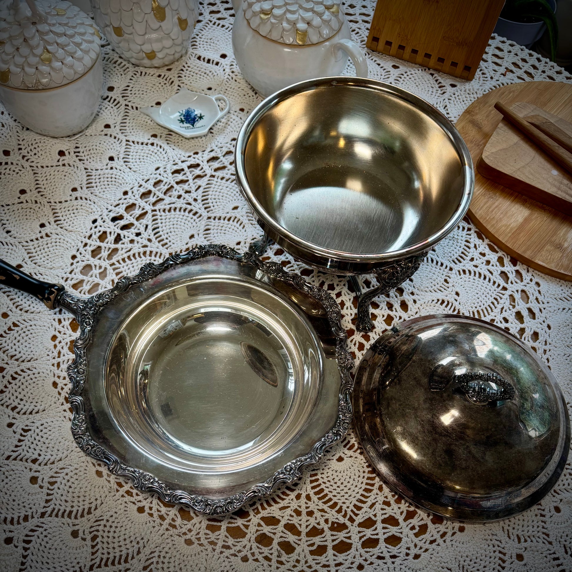A vintage silver chafing dish with a lid with all pieces shown separate