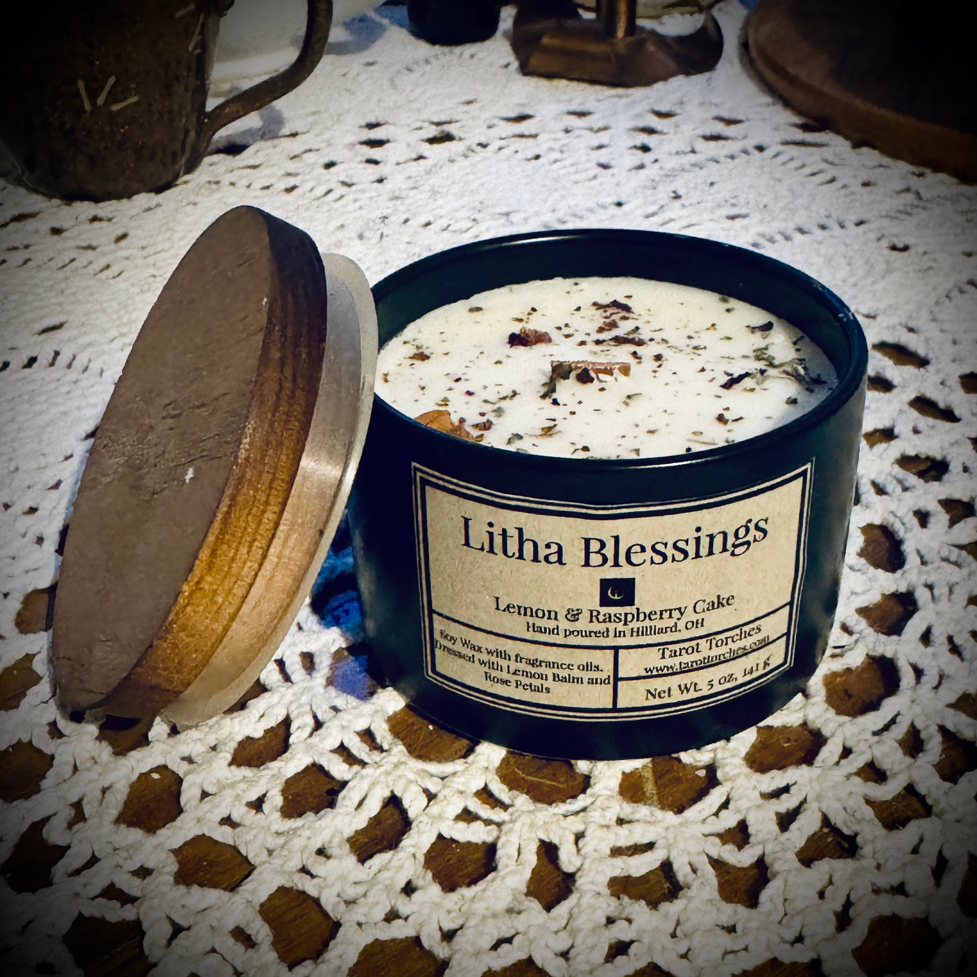 Candle labeled 'Litha Blessings' on a white lace cloth.