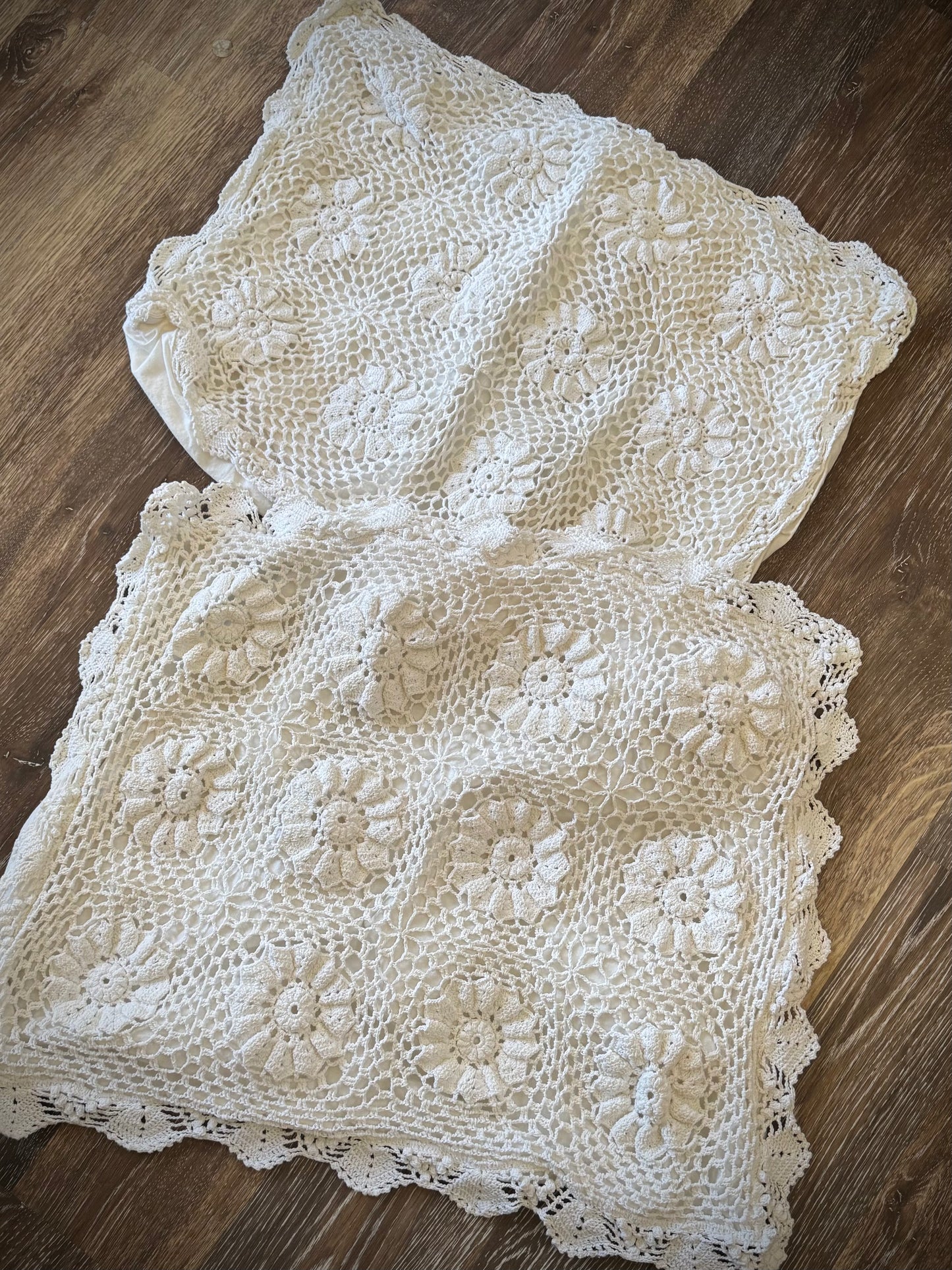 Two vintage crochet pillowcases laid out on a flat surface.