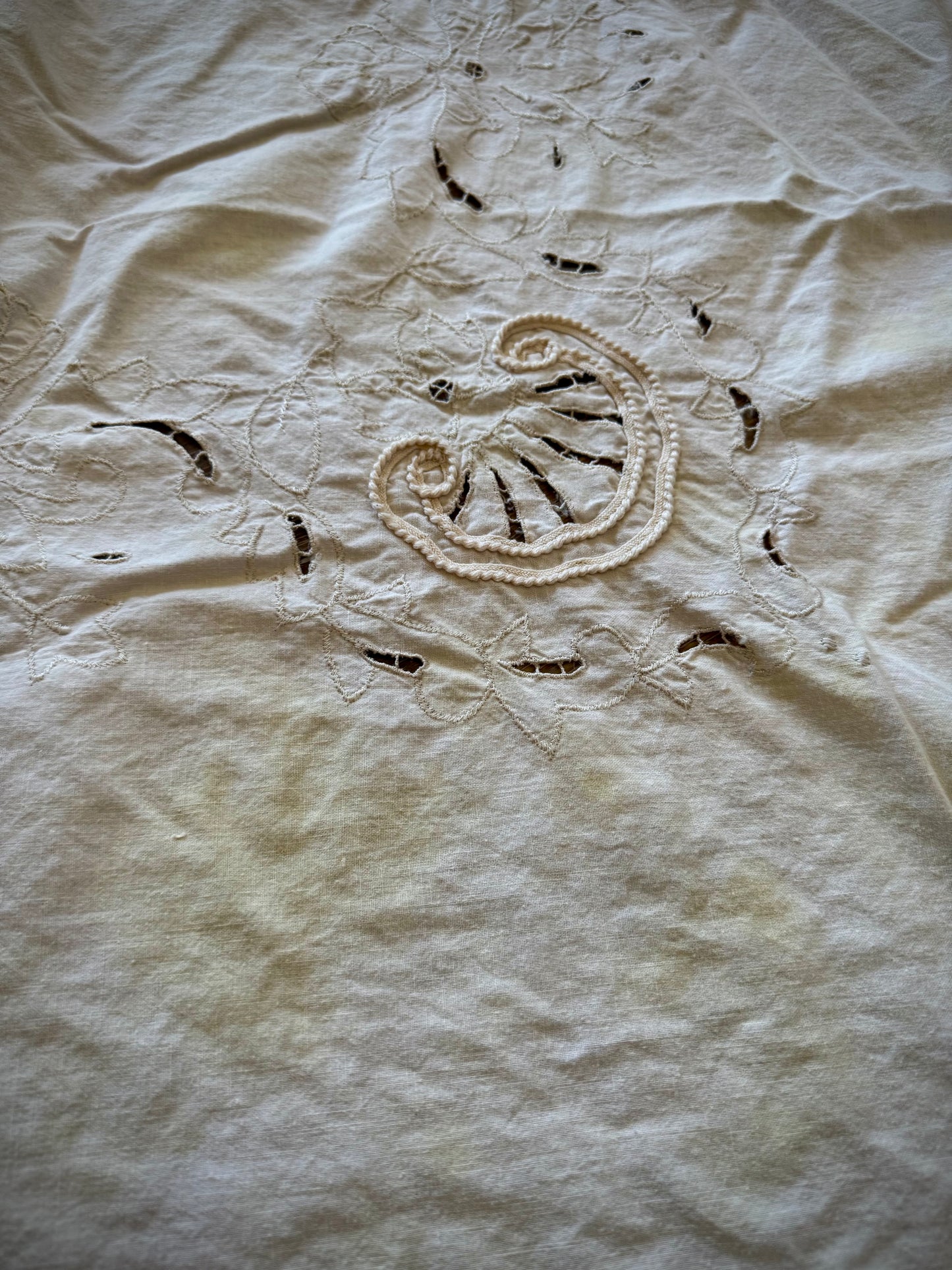 Close up of a discoloration near embroidery details on a tablecloth