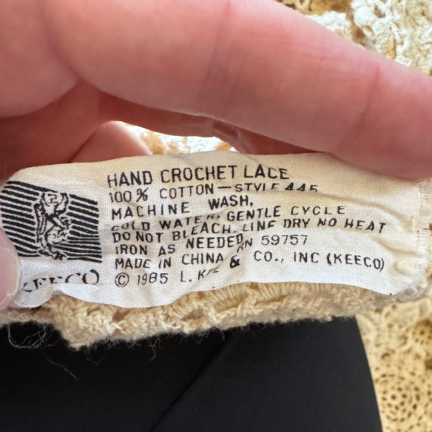 Tag reading "Hand Crochet Lace, 100% Cotton" with washing details, dated 1985